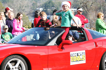 Georgia Anne  and Jack Butler tossing candy at the 2011 Christmas parade